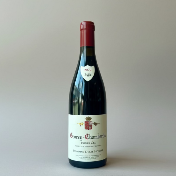 Bottle of Denis Mortet Gevry Chambertin 1er Cru on plain background
