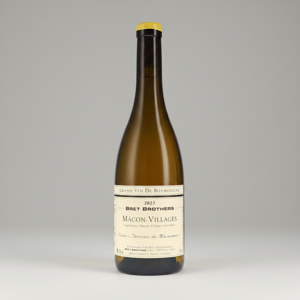 A bottle of Bret Brothers Màcon-Villages Grand Vin de Bourgogne red wine, featuring a dark amber glass body, a black neck, a yellow-gold foil top, and a cream-colored label with black text.