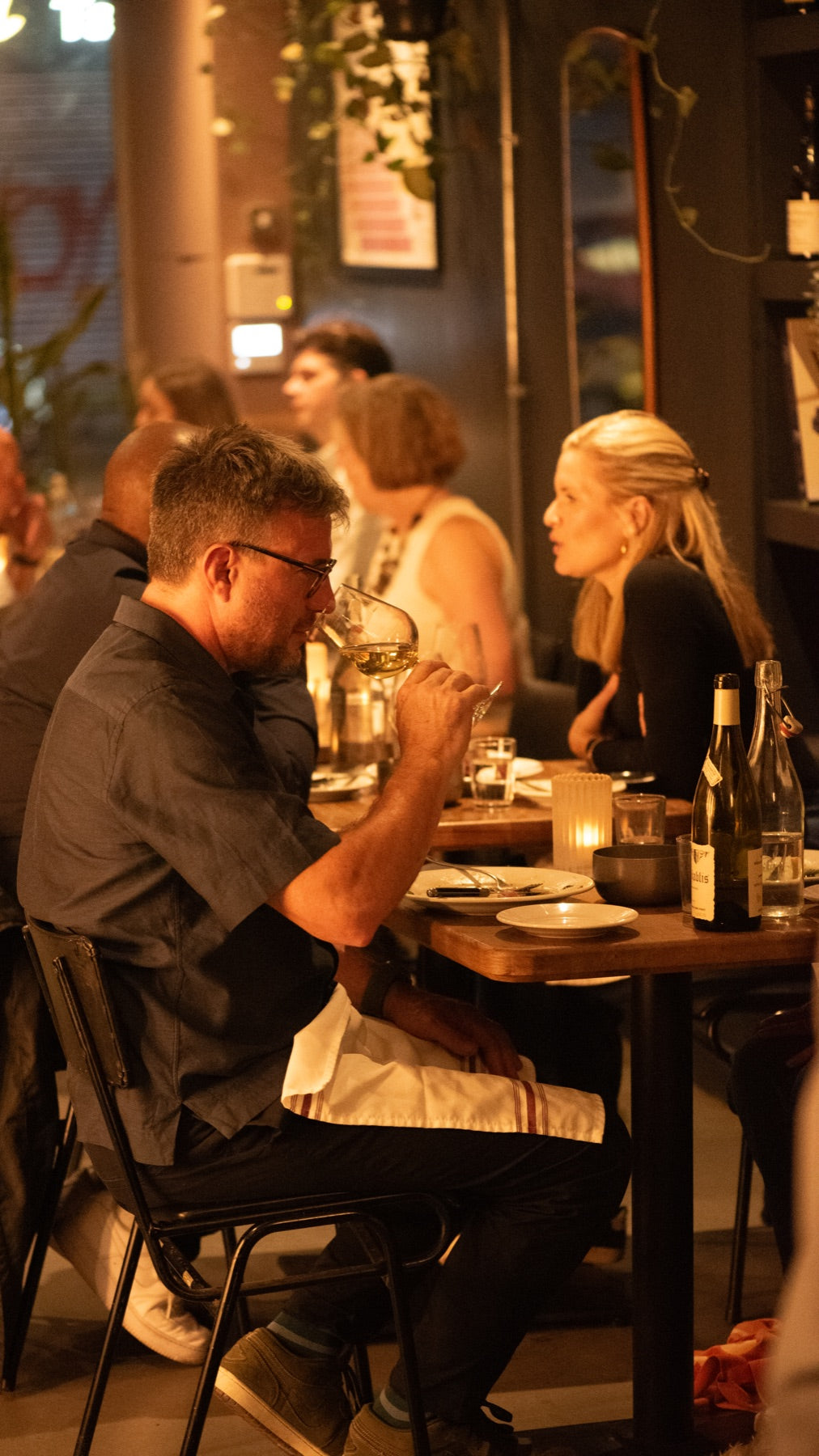 Guests enjoying wine and dinner at Cave