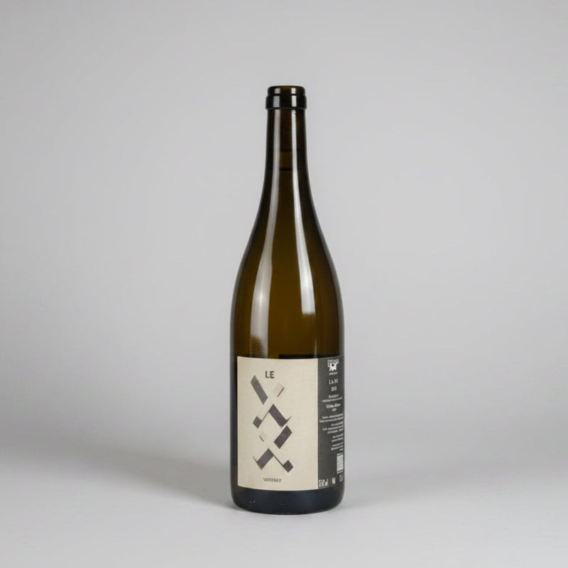 A dark glass bottle of Goustine Le XX Vouvray wine with a minimalist black and beige label.